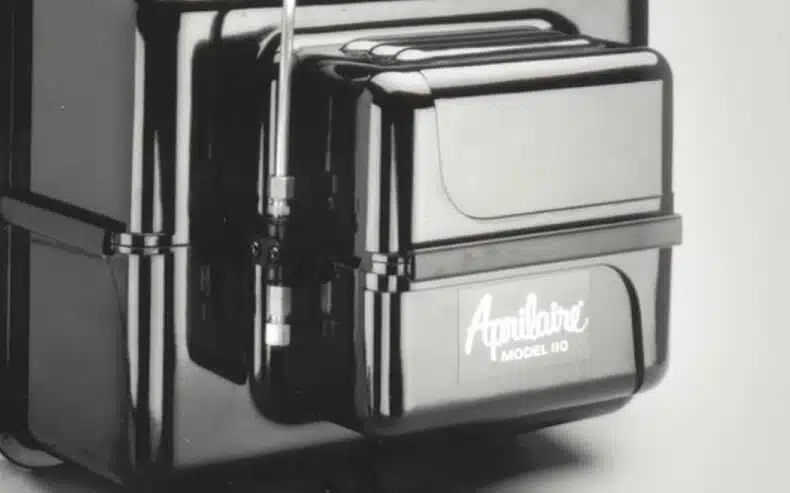 Close-up of a classic black AprilAire Model 110 humidifier highlighting the original brand logo and industrial design.